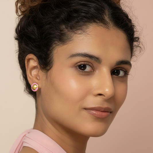 Girl Wearing a gold and Pink Earring