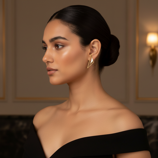 Woman wearing iris earrings in a dimly lit room