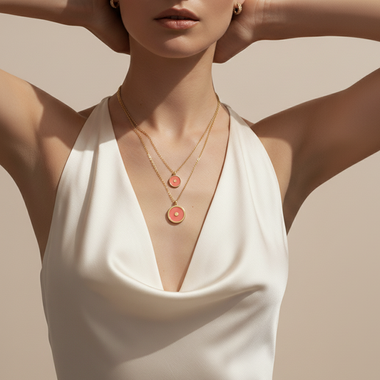 Woman wearing a white dress with layered necklaces on a beige background