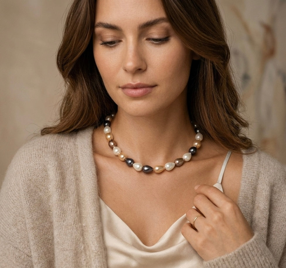 Woman wearing a pearl necklace with a neutral background