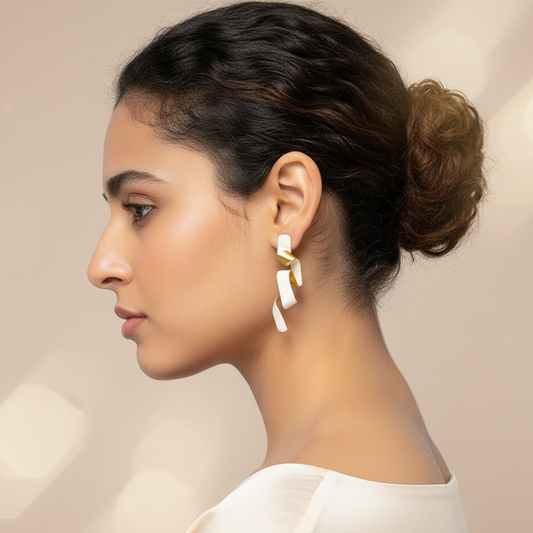 Woman wearing a white top with a neutral background and Tulip Twirl Earrings